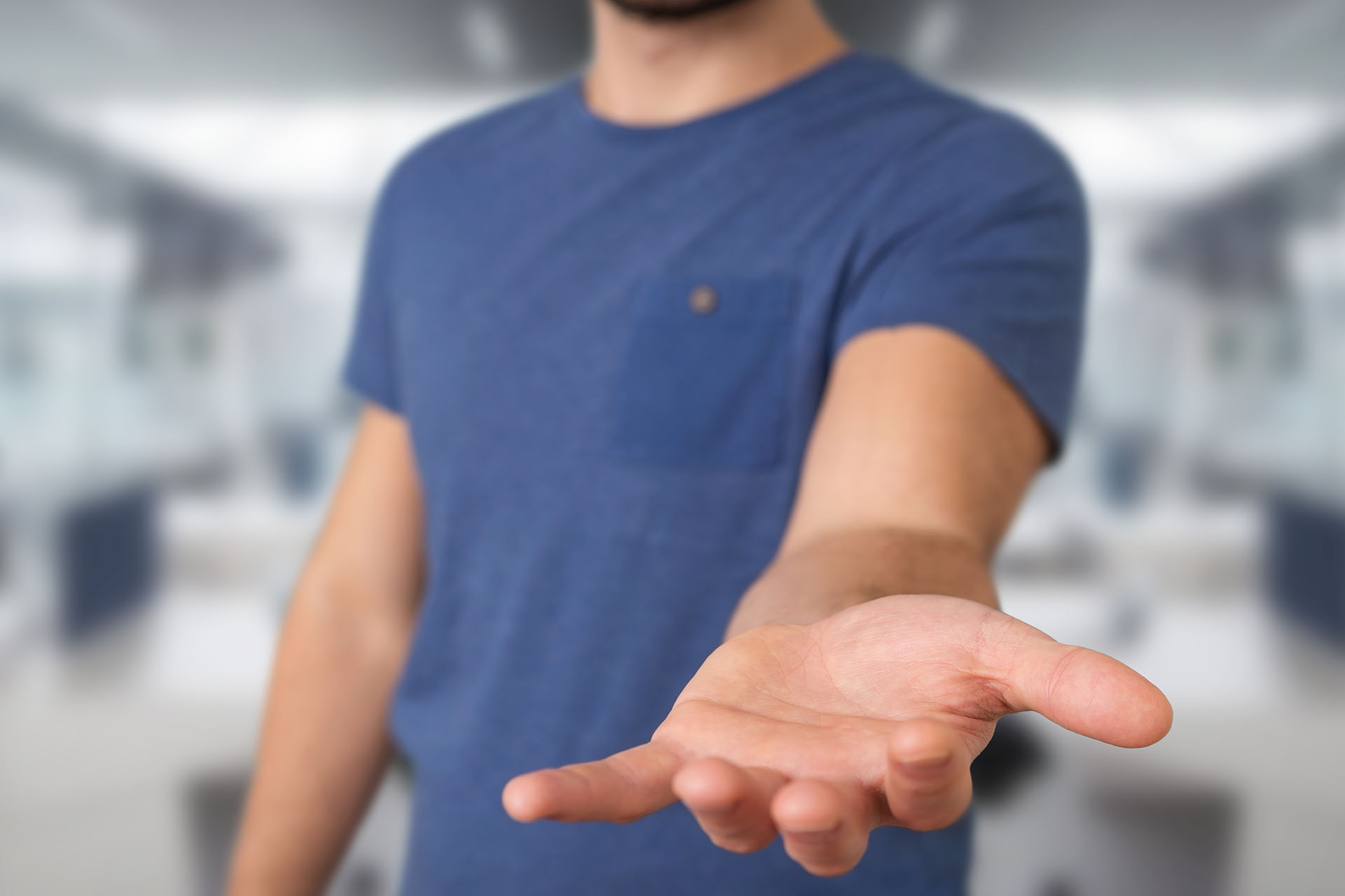 Man holding out hand in a welcoming gesture.